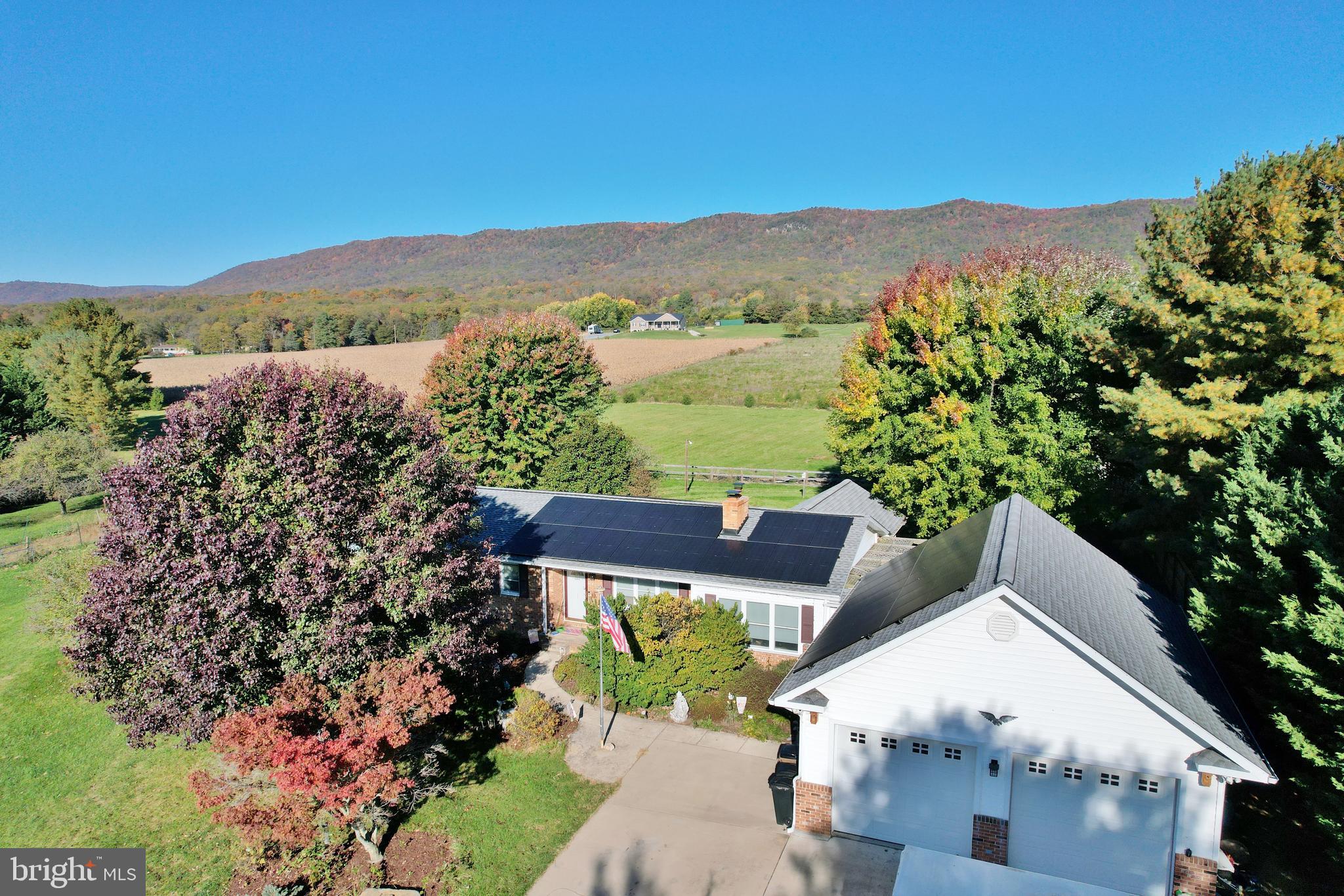 a view of a house with a mountain in the background