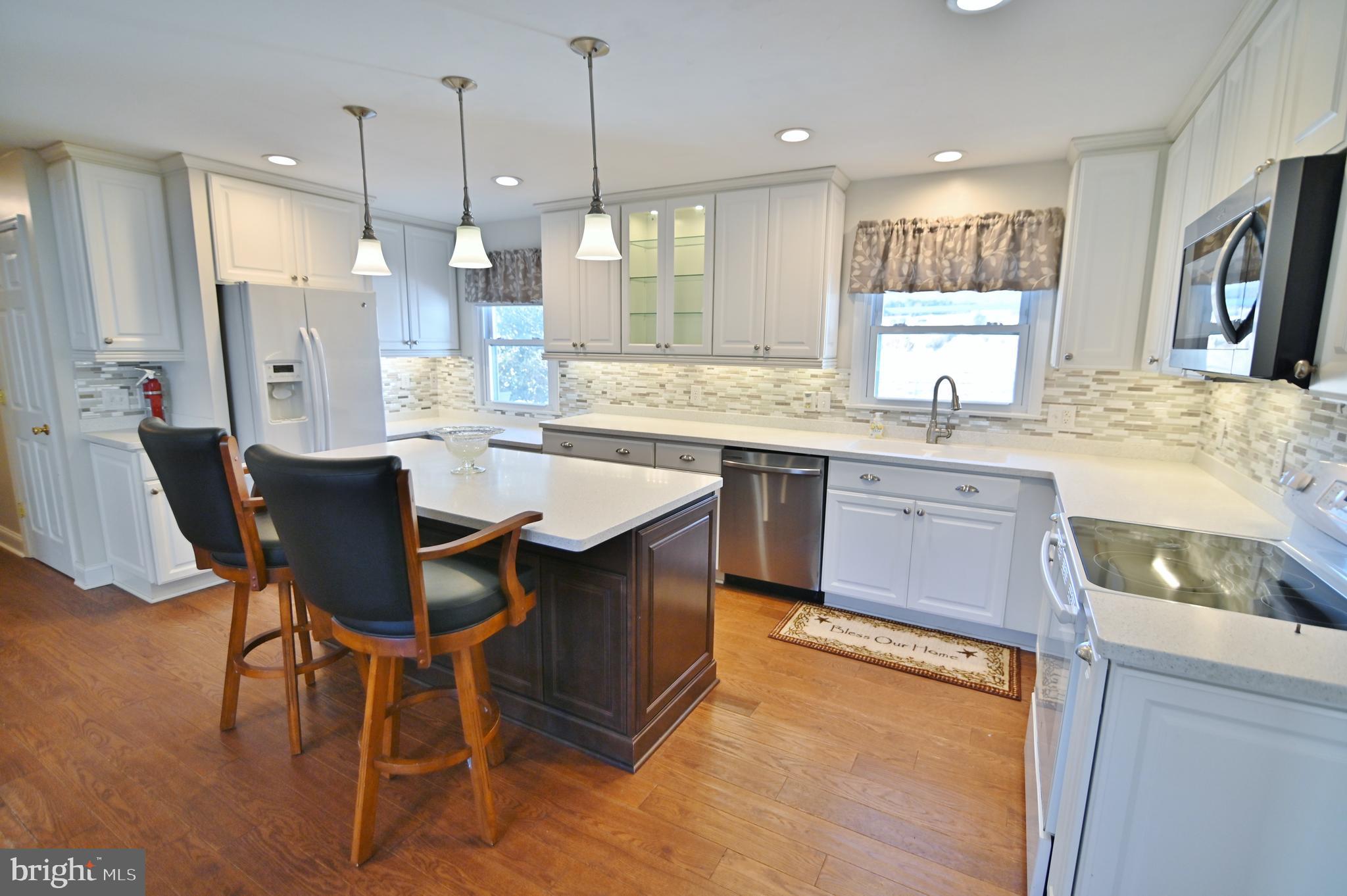 8289 Back Road Maurertown, VA 22644 - Photo 25 of 59 a large kitchen with a table and chairs in it