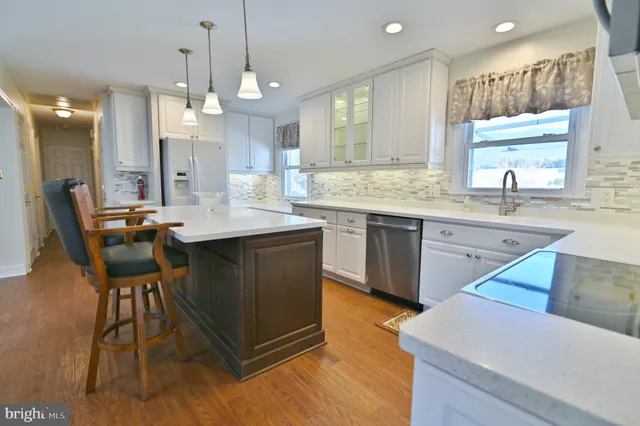 a view of an empty room with a fireplace and a window