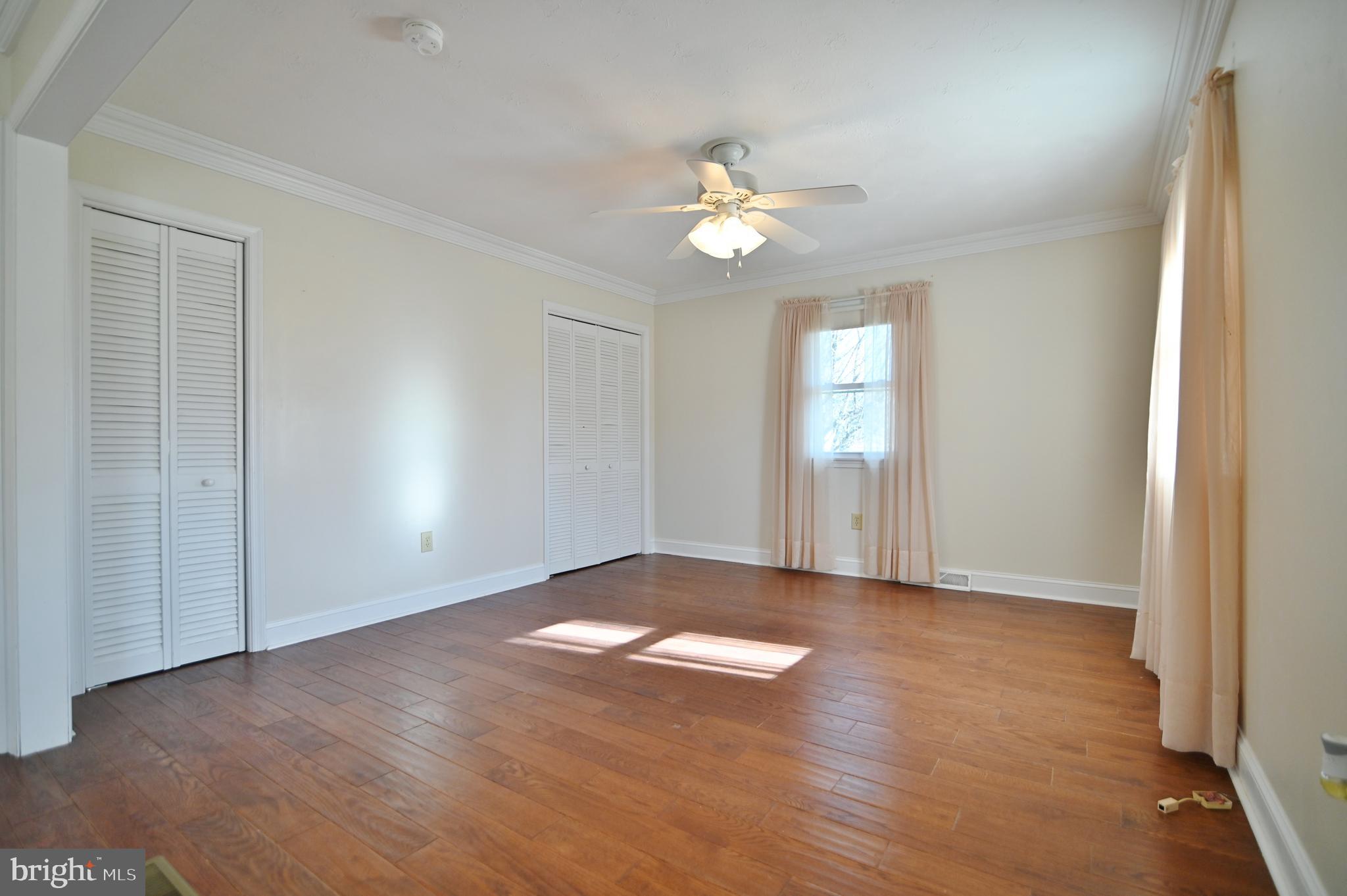 8289 Back Road Maurertown, VA 22644 - Photo 40 of 59 an empty room with wooden floor and ceiling fan