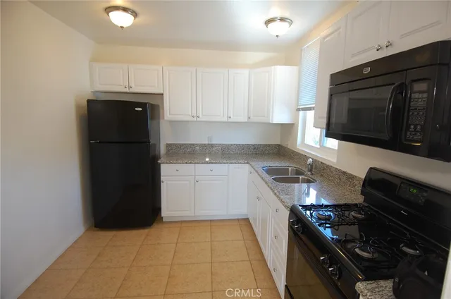 a kitchen with a refrigerator stove and microwave