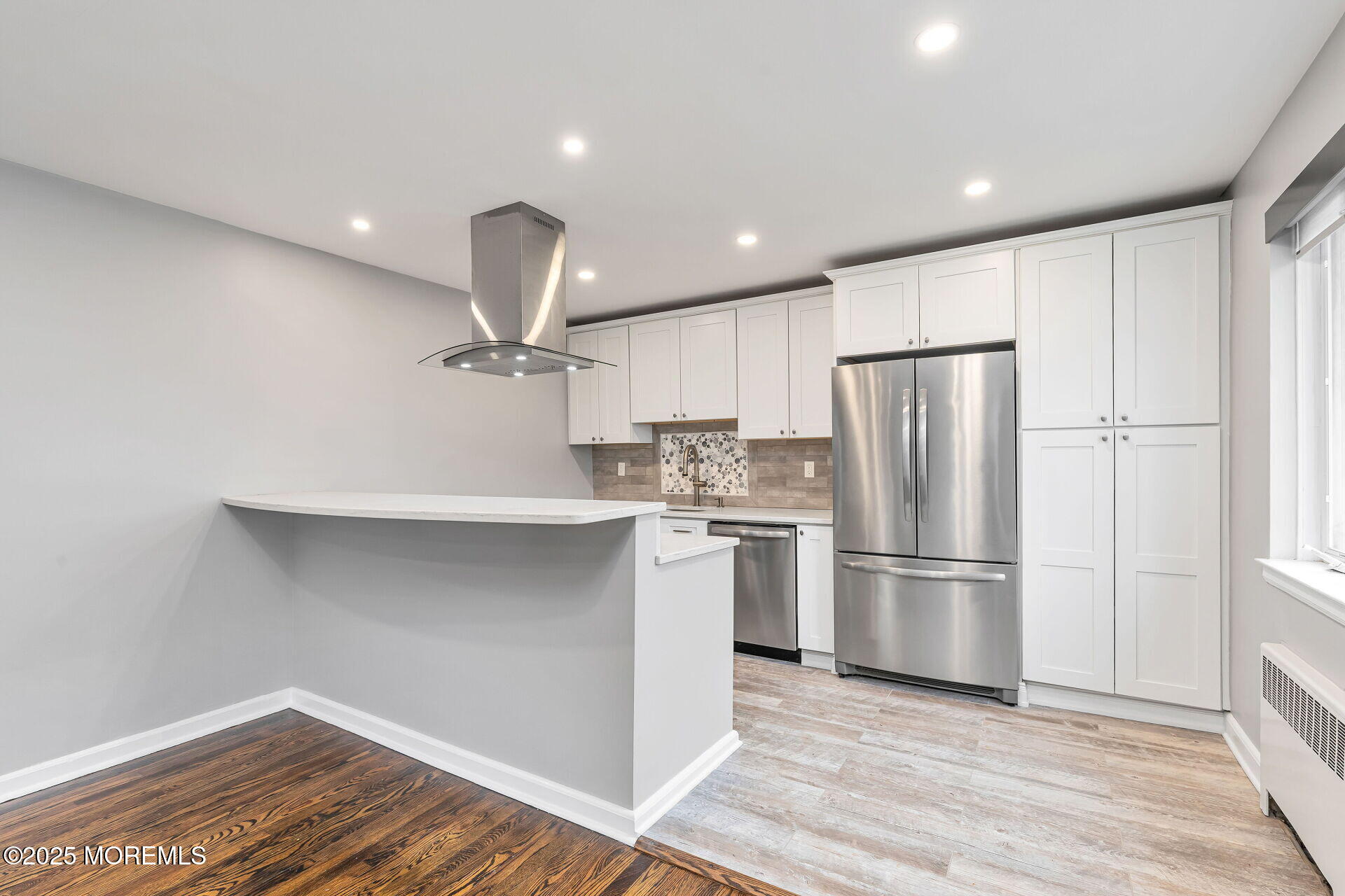 293 Spring Street, Unit 15D Red Bank, NJ 07701 - Photo 8 of 28 a kitchen with refrigerator cabinets and wooden floor