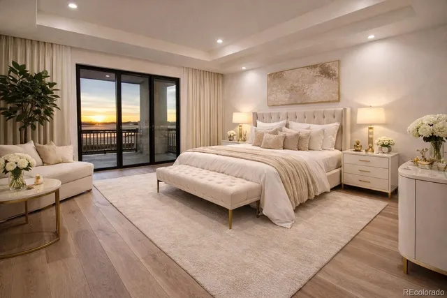 a bedroom with a large bed couch and a large window