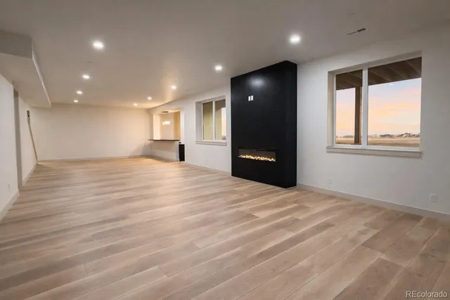 a living room with fireplace furniture and a potted plant