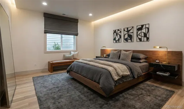 a bedroom with a bed and a potted plant