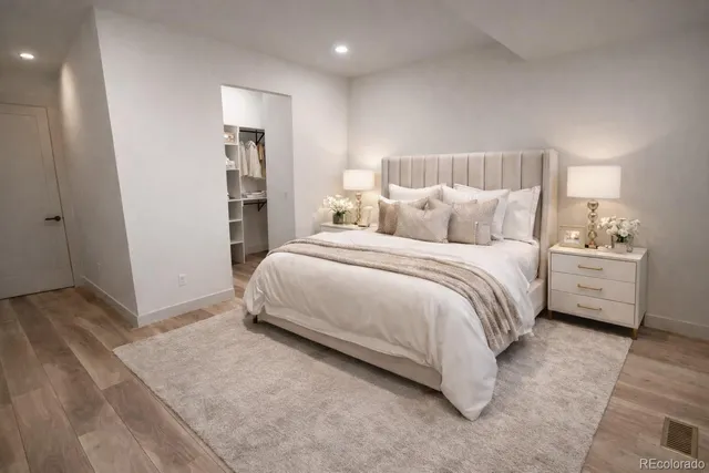 a bedroom with a bed and a lamp