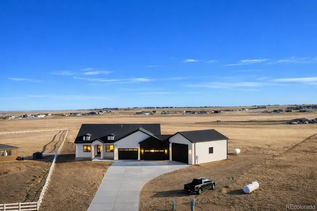 a view of a terrace with lawn chairs