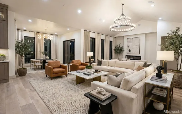 a living room with furniture and a chandelier