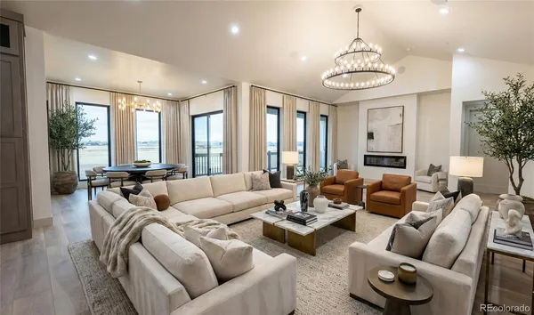 a living room with furniture potted plant and a chandelier