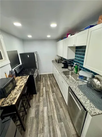 a kitchen with a stove a sink and a refrigerator