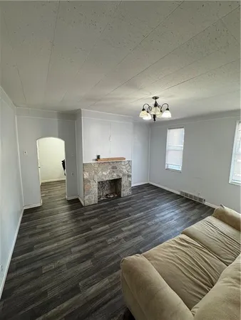 a view of a livingroom with wooden floor and a ceiling fan