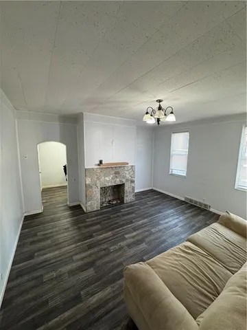 a view of a livingroom with wooden floor and a ceiling fan