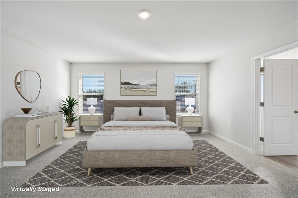 391 Tallulah Lane Grayson, GA 30017 - Photo 21 of 35 a bedroom with a large bed and a chandelier