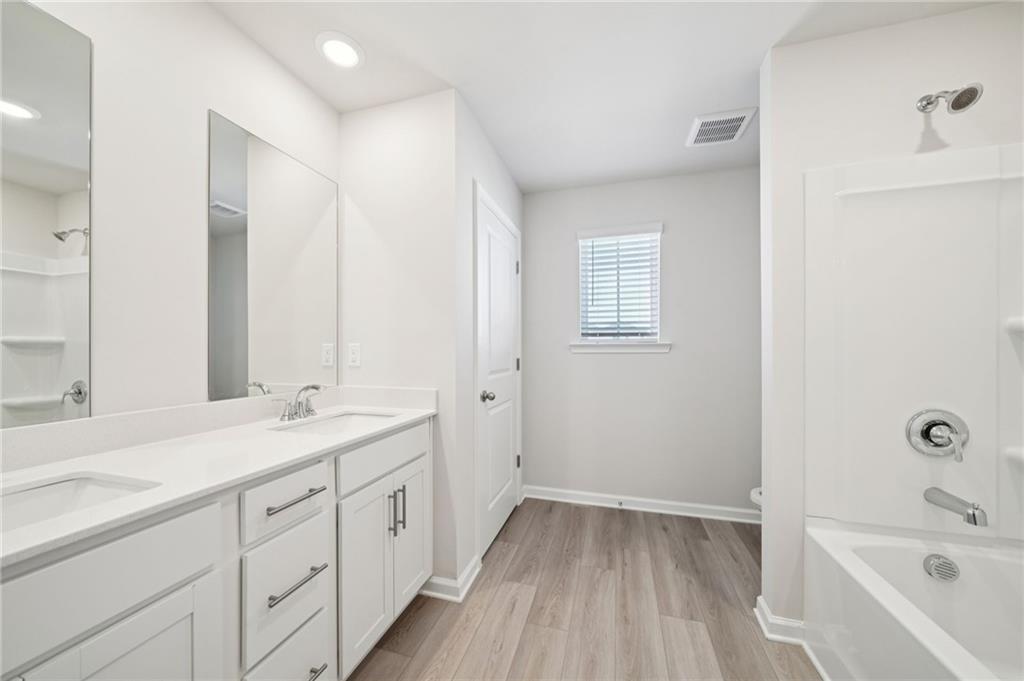 391 Tallulah Lane Grayson, GA 30017 - Photo 27 of 35 a spacious bathroom with a tub sink and mirror
