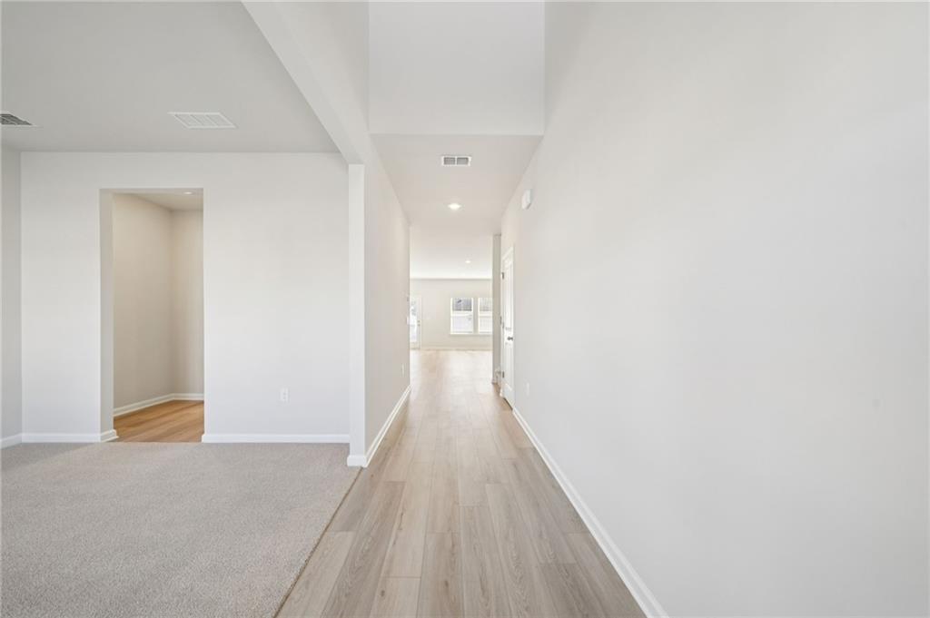 391 Tallulah Lane Grayson, GA 30017 - Photo 4 of 35 a view of a hallway with wooden floor