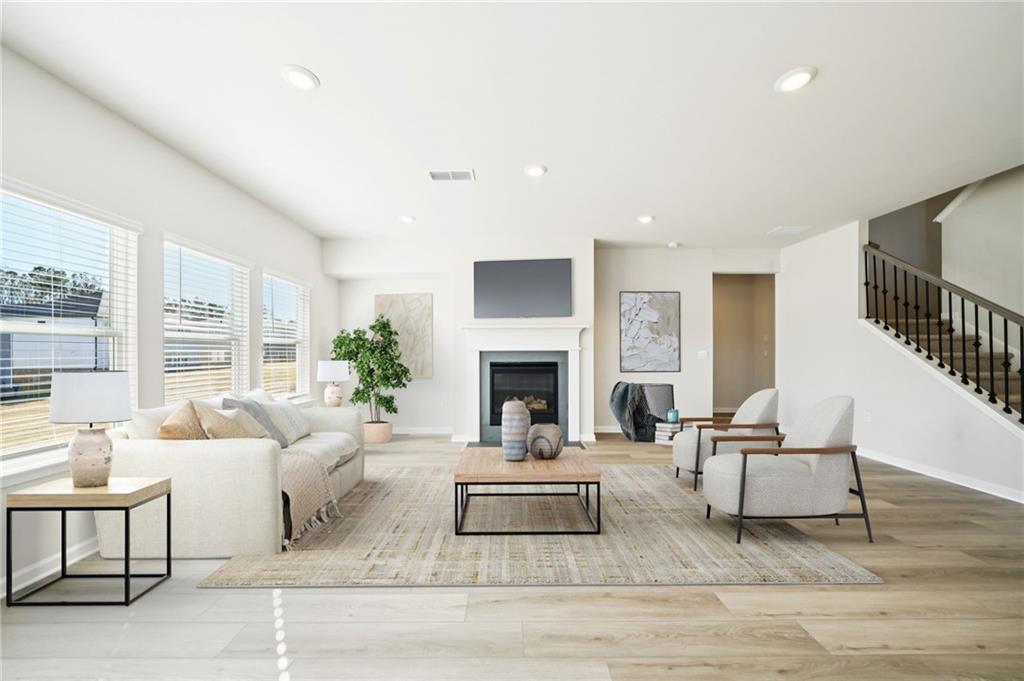 391 Tallulah Lane Grayson, GA 30017 - Photo 6 of 35 a living room with furniture and a fireplace