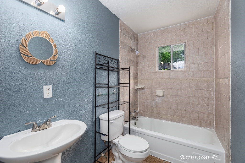 2915 Freeman Street Lufkin, TX 75901 - Photo 25 of 33 a bathroom with a sink a toilet and shower
