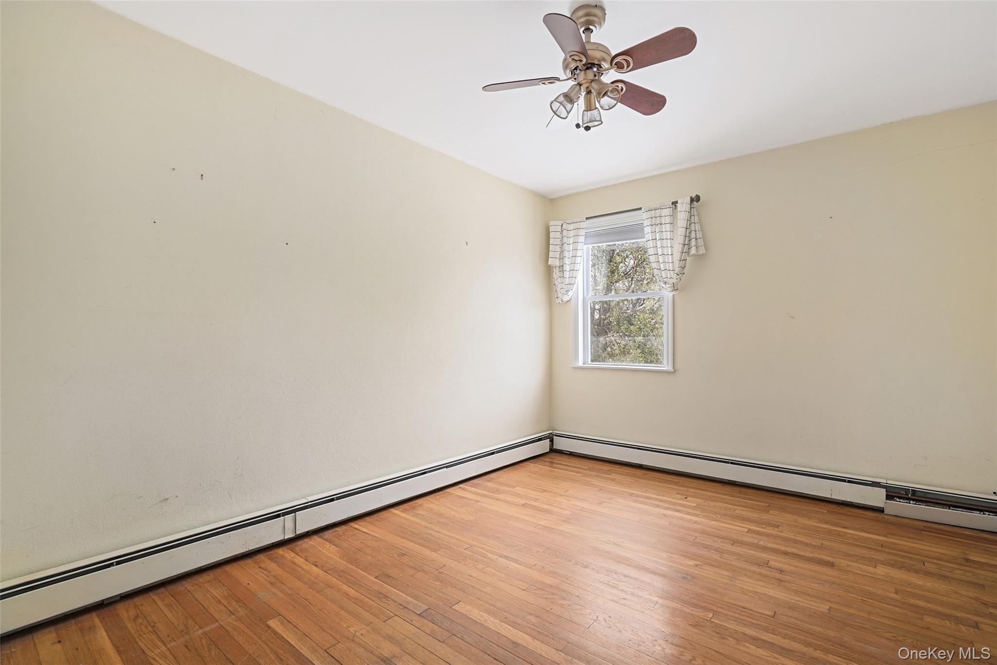 22 Raspberry Lane Carmel, NY 10512 - Photo 11 of 23 an empty room with a window and a ceiling fan