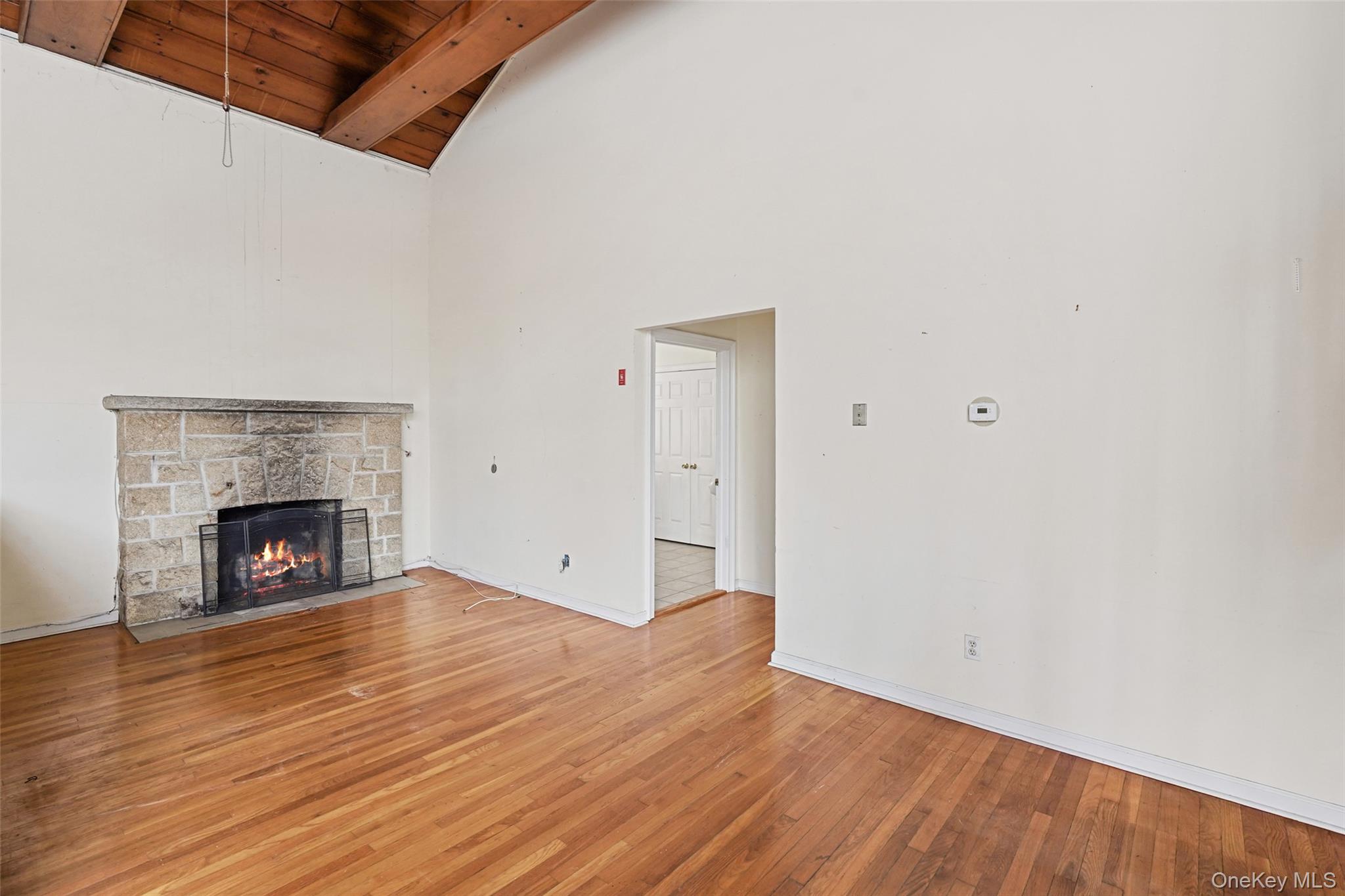 22 Raspberry Lane Carmel, NY 10512 - Photo 16 of 23 a view of an empty room with wooden floor fireplace and a window