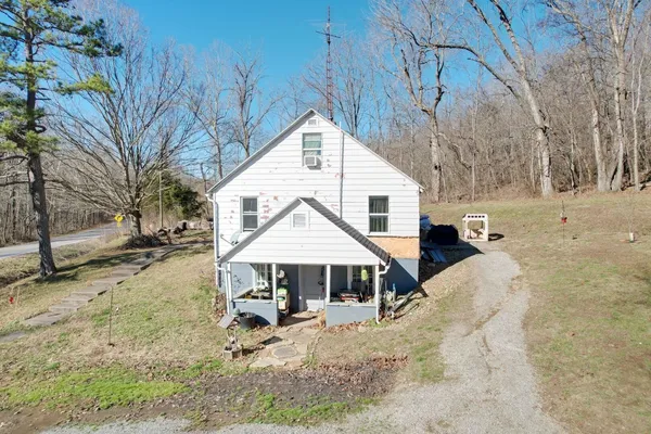 a view of a house with a yard covered in snow