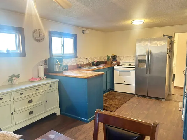 a kitchen with stainless steel appliances granite countertop a refrigerator and a sink