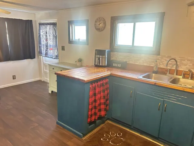 a bathroom with a tub sink and mirror