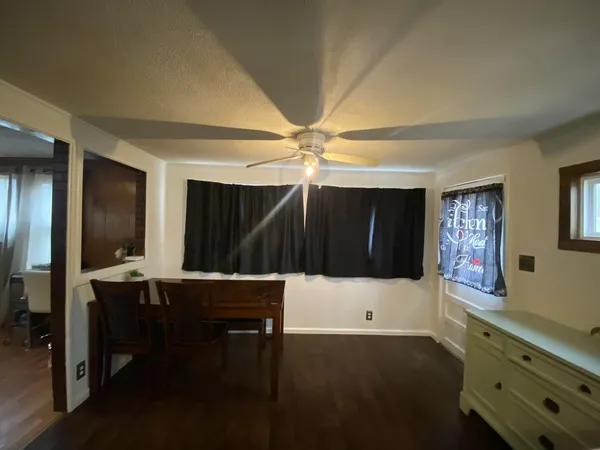 a view of a hallway to a livingroom with furniture