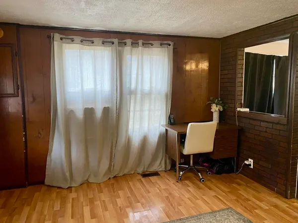 a bedroom with a bed and a couch