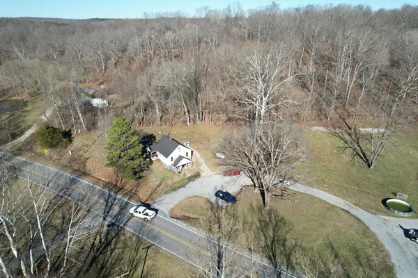 a view of a backyard with a deck and a garden