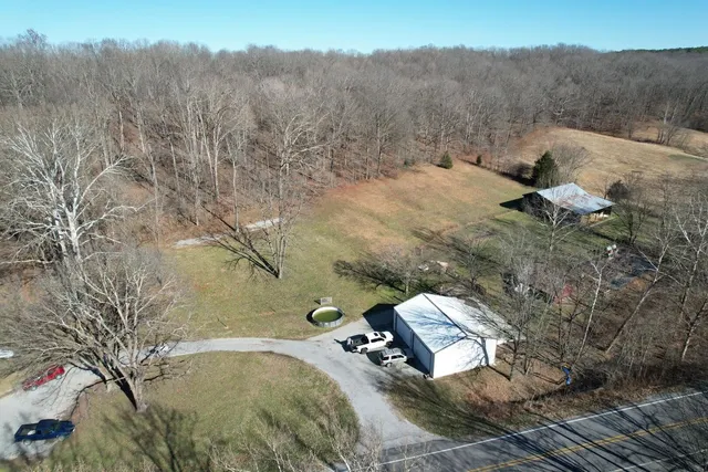 a view of a backyard with wooden fence