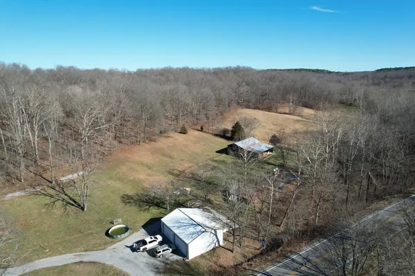 a view of a dry yard with mountains in the background