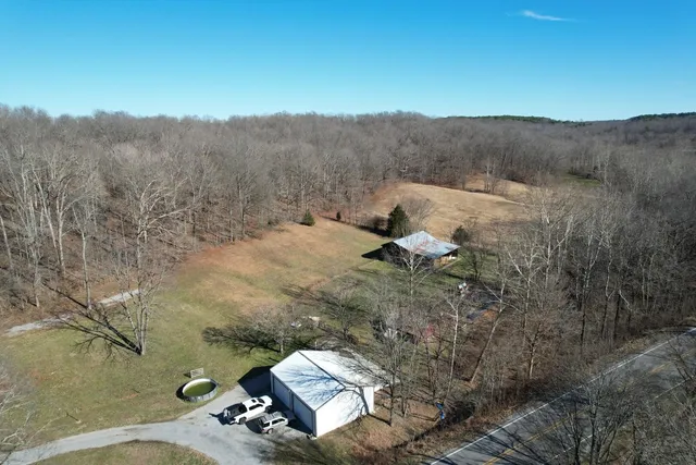 a view of a dry yard with mountains in the background