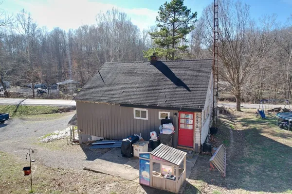 a view of a fire pit with large trees