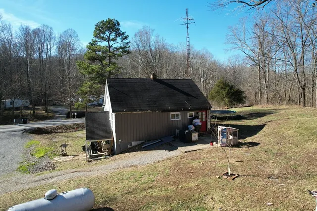 a view of a dry yard with wooden fence