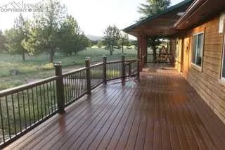 a view of a balcony with wooden floor