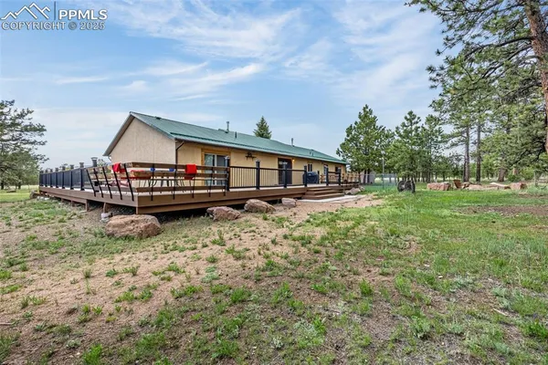 a view of house with yard and entertaining space