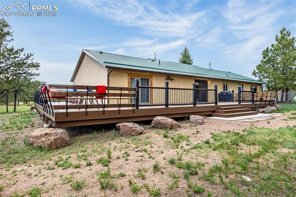 a view of a house with wooden fence
