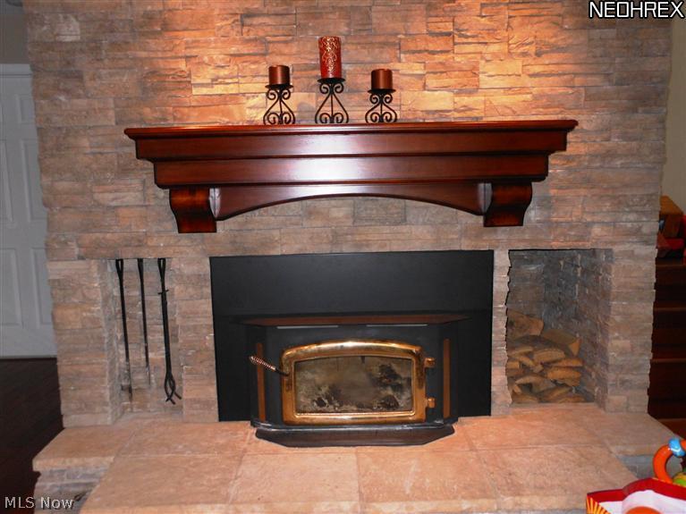 8912 Broadview Road Broadview Heights, OH 44147 - Photo 17 of 20 Close up of stone fireplace with wood stove insert in Living room...