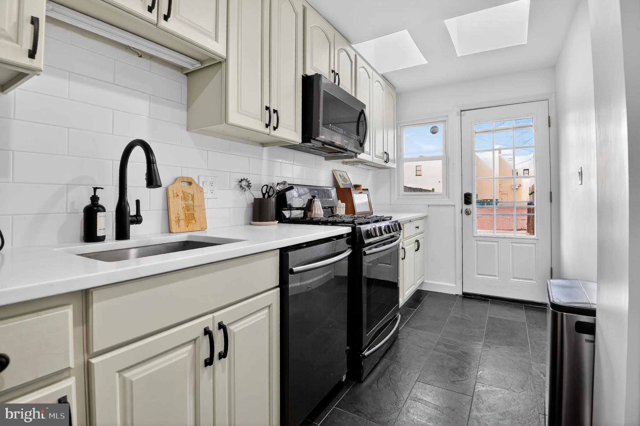 315 16th Street Southeast Washington, DC 20003 - Photo 11 of 21 a kitchen with stainless steel appliances granite countertop a sink a stove a refrigerator and cabinets