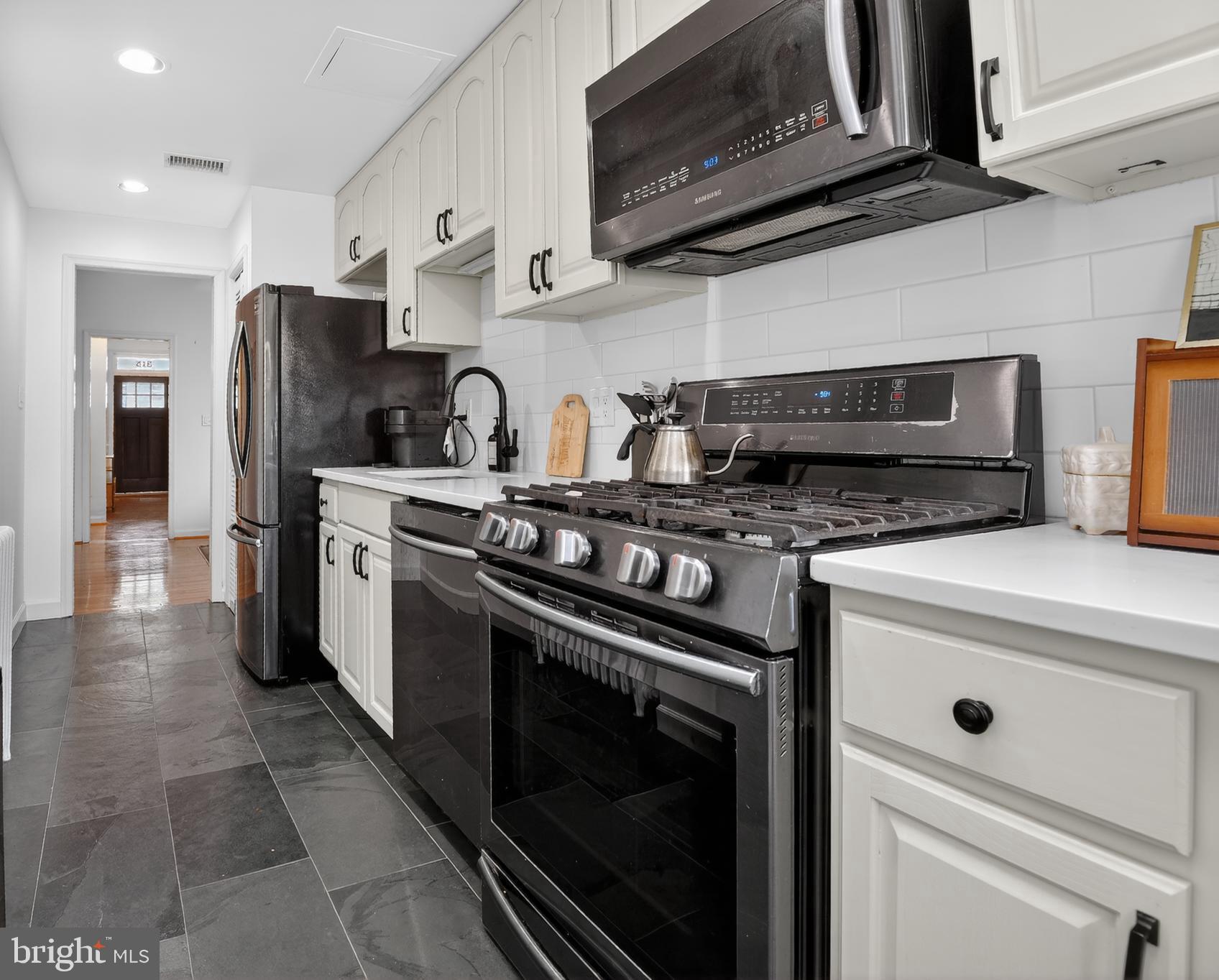 315 16th Street Southeast Washington, DC 20003 - Photo 12 of 21 a kitchen with stainless steel appliances granite countertop a stove and a microwave