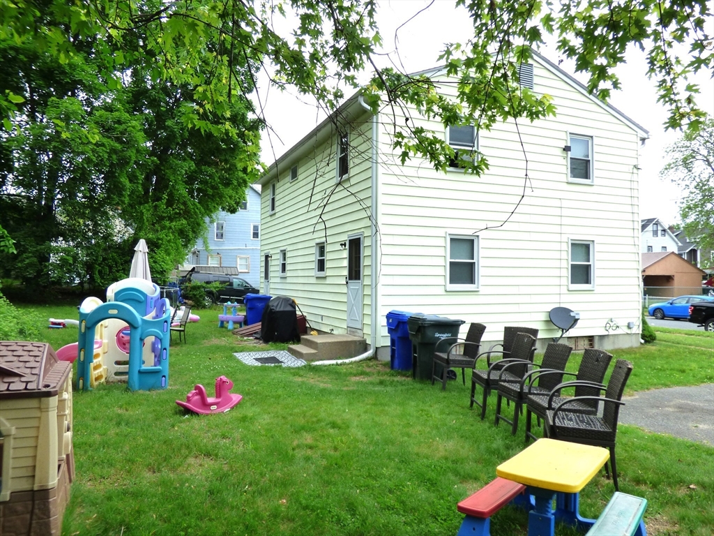16-18 Daniel Street Springfield, MA 01151 - Photo 2 of 14 a view of a back yard with a table and chairs in back yard