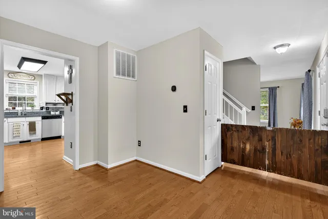 a view of a kitchen with a sink and a refrigerator