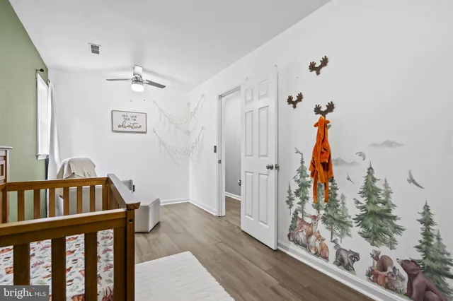 a view of a hallway with wooden floor and stairs