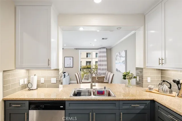 a kitchen with sink refrigerator and cabinets