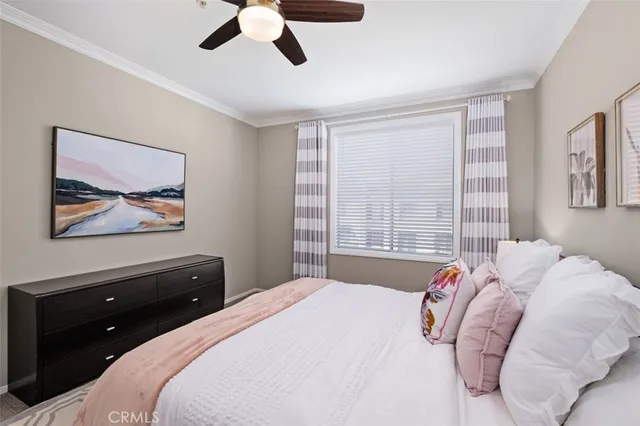 a bedroom with a bed and a large window