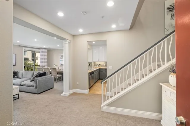 a view of staircase with furniture and windows
