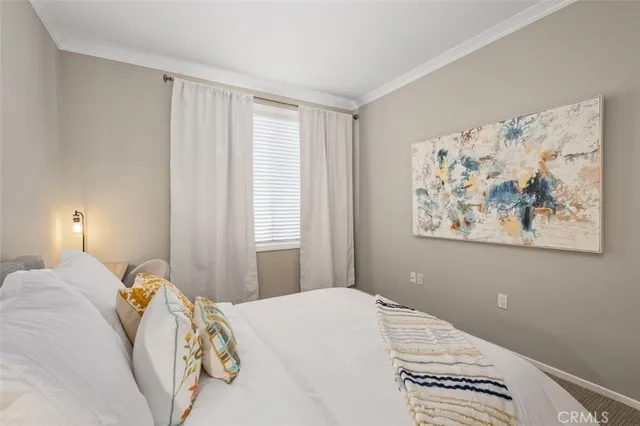 a bedroom with a bed and a painting on the wall