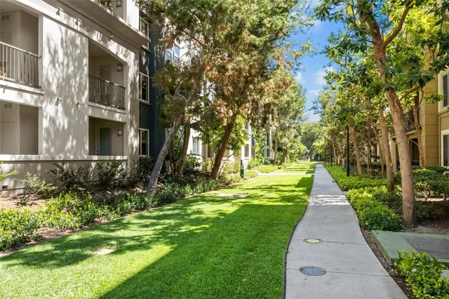 a view of a patio with couches and table and chairs and potted plants