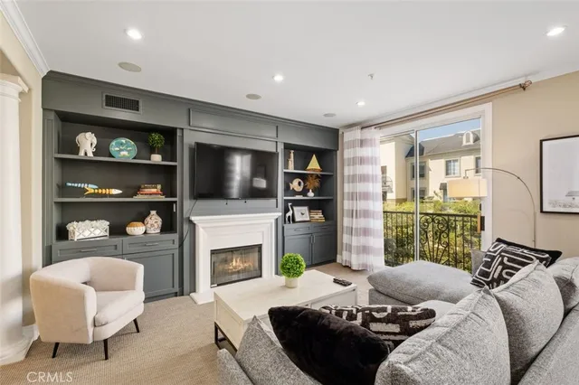 a living room with furniture a flat screen tv and a fireplace