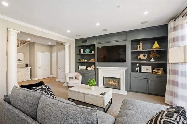 a living room with furniture a flat screen tv and a fireplace